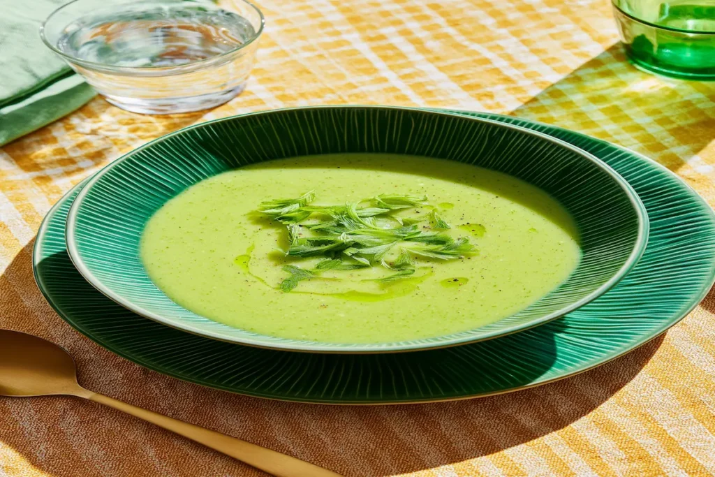 Zucchini broccoli soup in a bowl, creamy and light with fresh vegetables