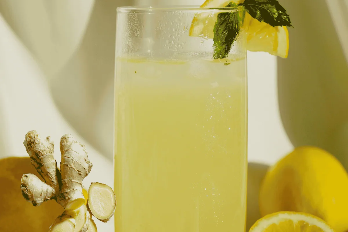 Fresh homemade Ginger lemon drink served in a glass with fresh lemon slices and ginger, perfect for a refreshing homemade recipe